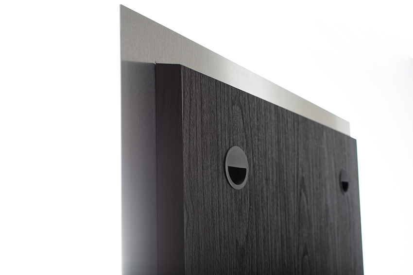 The back of a metal print showing the floating mount system and dark wood backing